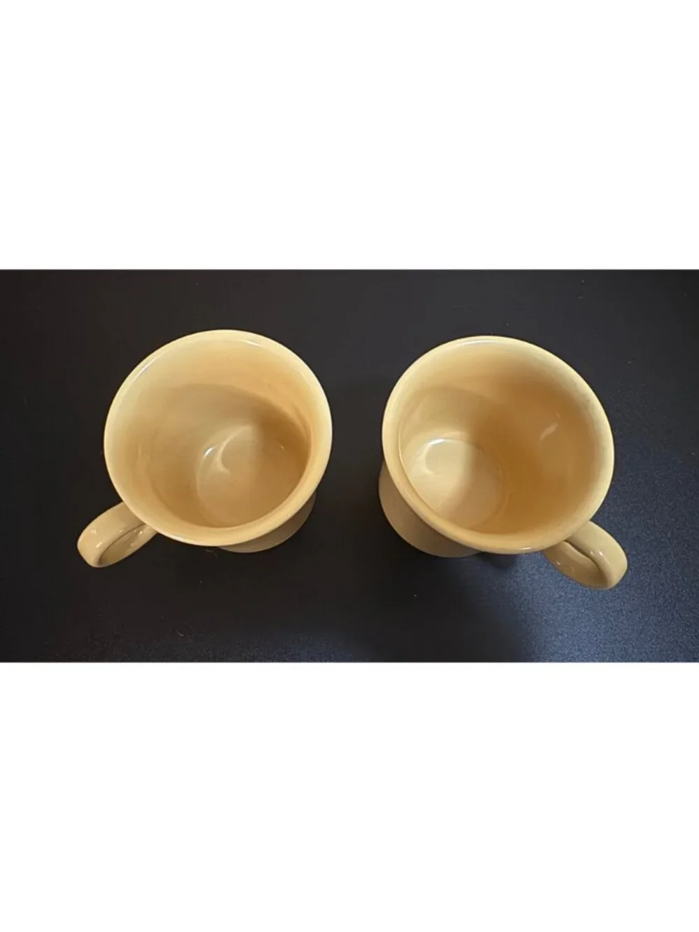 Pair of Fiesta Ware mugs in a light yellow glaze